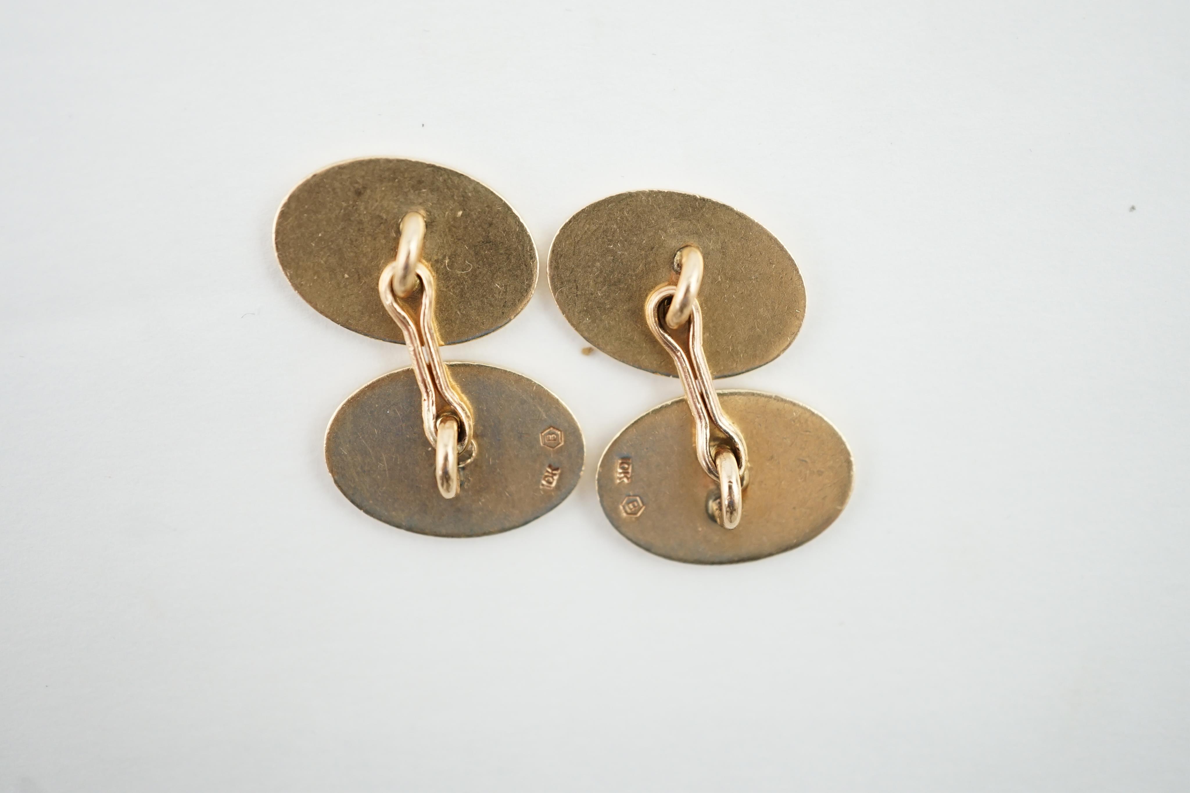 A pair of diamond set 10k gold cufflinks